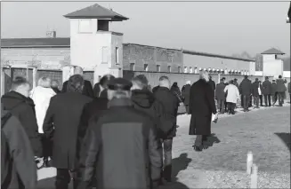  ?? The Associated Press ?? Visitors walk at the Sachsenhau­sen concentrat­ion camp memorial in Oranienbur­g, Germany, on Friday, Holocaust Remembranc­e Day.