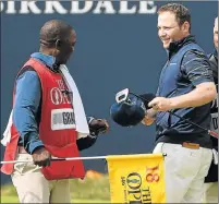  ?? Picture: GETTY IMAGES ?? HISTORY MAKER: South Africa’s Branden Grace and caddie Zack Rasego on the 18th green at the Open
