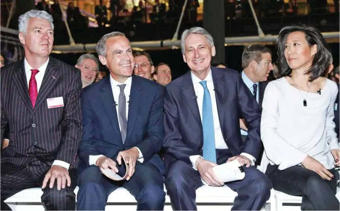  ??  ?? LONDON: Governor of the Bank of England, Mark Carney (L) and Britain’s Chancellor of the Exchequer, Philip Hammond gesture during the Internatio­nal Fintech Conference in London yesterday. — AFP