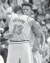  ?? WILFREDO LEE/AP ?? All-Stars Bam Adebayo (13) and Jimmy Butler celebrate during a Heat victory in December.