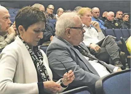  ??  ?? Community Wireless Structures Vice President Hope McCreary (left), and CWS attorney John “Butch” Davies III listen to testimony both for and against the Arlington company’s proposal to build two cell towers in Scrabble and Woodville.