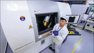  ?? LIN SHANCHUAN / XINHUA ?? A technician of Contempora­ry Amperex Technology Co Ltd checks an electric vehicle battery at the company’s plant in Ningde, Fujian province.