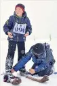  ?? ZHAO GE / XINHUA ?? Children prepare for a “fur skis” contest on Jan 1 in Altay.