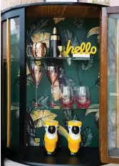  ??  ?? By wallpaperi­ng the back of this cabinet Becky has added an extra hit of pattern. ‘It really adds to the tropical feel, and my parrot candlehold­ers look right at home,’ she says