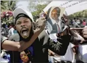  ?? Fernando Llano Associated Press ?? CROWDS CHEER for former Haitian President Jean-Bertrand Aristide at a Port-au-Prince airport.