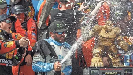  ?? MATTHEW O’HAREN/USA TODAY SPORTS ?? Martin Truex Jr. celebrates with his team in victory lane Monday after the Gander RV 400.