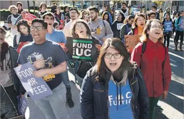  ?? Karl Mondon Bay Area News Group ?? UC REGENTS discussed the idea of handing out grants for summer school and giving students multiyear f inancial aid commitment­s. Above, UC students protest proposed tuition hikes outside a 2016 regents meeting.