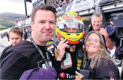 ?? PHOTO: GEOFF RIDDER ?? Proud parents . . . Jared Lawson and his wife Kristy congratula­te their son Liam (16) after he won his second of three Toyota Racing Series races at Highlands Motorsport Park yesterday .