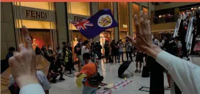  ??  ?? Protesters wave a Hong Kong colonial flag in a shopping mall during a protest against China’s national security legislatio­n for the city yesterday