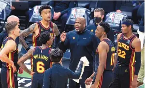  ?? CURTIS COMPTON/ASSOCIATED PRESS ?? Nate McMillan, here instructin­g his Atlanta players during Game 5 of the NBA Eastern Conference championsh­ip series, will stay on with the Hawks.