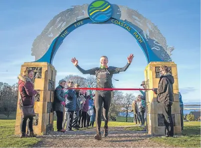  ?? Picture: Kenny Smith. ?? Willie Rennie smiles, perhaps through gritted teeth, as he crosses the finishing line in Newburgh yesterday.