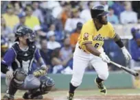  ??  ?? Danny Santana conecta un doble al abridor del Licey, Mario Santiago, uno de los tres hits que coleccionó en el juego.