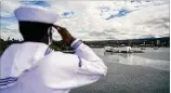  ?? U.S. NAVY VIA AP ?? Seaman Belo Kipkirui salutes as the guided-missile destroyer USS Michael Murphy passes by the USS Arizona Memorial in Hawaii’s Pearl Harbor during a ceremony for the 75th anniversar­y of the Japanese surrender that ended World War II.