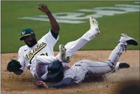  ?? JEFF CHIU — THE ASSOCIATED PRESS ?? The Houston Astros’ Chas McCormick scores with a headfirst slide under Oakland Athletics pitcher Reymin Guduan during the ninth inning on Saturday at the Coliseum.