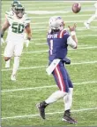  ?? Kathryn Riley / Getty Images ?? QB Cam Newton of the Patriots catches a TD pass against the Jets on Sunday.