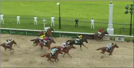  ?? NBC SPORTS VIA AP ?? In this image taken from video, Secretaria­t, right, crosses the finish line to win a computersi­mulated version of the Kentucky Derby between the 13winners of the Triple Crown.