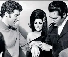  ??  ?? Priscilla Presley looks on as Elvis checks out Tom Jones’ new watch backstage in Las Vegas in 1971