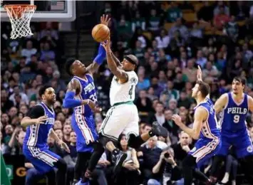  ??  ?? Boston Celtics guard Isaiah Thomas (4) passes the ball as he is covered by the Philadelph­ia 76ers during the second half of an NBA basketball game in Boston,