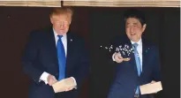  ?? (Jonathan Ernst/Reuters) ?? US PRESIDENT Donald Trump and Japan’s Prime Minister Shinzo Abe feed carps yesterday before their working lunch at Akasaka Palace in Tokyo.