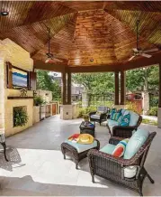  ??  ?? Custom-milled cedar columns hold up the eightsided vaulted ceiling that’s covered underneath with stained pine.