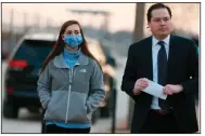  ?? (AP/St. Louis Post-Dispatch/Christian Gooden) ?? Emily Hernandez, who is accused of being in the U.S. Capitol during the Jan. 6 riot and stealing a broken sign that identified House Speaker Nancy Pelosi’s office, surrenders at the St. Louis FBI office Tuesday with her attorney, Ethan Corlija.