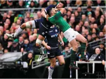 ?? RAMSEY CARDY/ SPORTSFILE ?? Ireland’s Rob Kearney and Scotland’s Ryan Wilson compete for a high ball at the Aviva Stadium