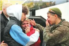  ?? Reuters ?? ■
A Russian reservist bids farewell to relatives before his departure for a base in the course of partial mobilisati­on of troops, in the town of Gatchina, Russia, yesterday.
