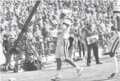  ?? STEVE SLADE/UCONN ?? UConn freshman quarterbac­k Tyler Phommachan­h celebrates a rushing touchdown against Army on Saturday in West Point, N.Y.