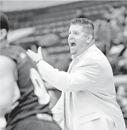  ?? CHARLES TRAINOR JR/MIAMI HERALD ?? Westminste­r Academy coach Ehren Wallhoff directs his boys basketball team in the Class 4A state semifinals in Lakeland on March 7, 2018. Wallhoff, who has been coaching the Lions since 2002, was named the school’s football coach after Tommy Lewis was let go.