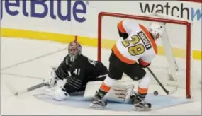  ?? JULIE JACOBSON — THE ASSOCIATED PRESS ?? Philadelph­ia Flyers center Claude Giroux (28) shoots and scores against New York Islanders goalie Jaroslav Halak (41) during a shootout Thursday in New York.