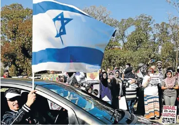  ?? /Alon Skuy ?? Targeted: South African Zionist Federation members rally in support of Israel in 2014 in Johannesbu­rg. Cosatu internatio­nal relations spokesman Bongani Masuku wrote about Jews who identify with Israel as if they support racism and fascism, the writer...