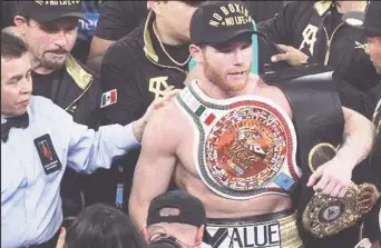  ??  ?? NEW CHAMP! Canelo Alvarez minutes after wresting Golovkin’s titles belts away from the former undisputed middleweig­ht champion. (Fightnews website)