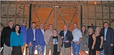  ?? ELISHA MORRISON/THE Saline Courier ?? Far left, guest speaker Coach Buck James stands with the Bryant Boys & Girls Clubs staff, volunteers and Hometown Hero honorees during the Hometown Heroes appreciati­on lunch on Friday at the Hill Barn Event Center.