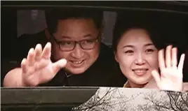  ??  ?? Secret visit: Kim Jong-un and his wife wave goodbye in Beijing