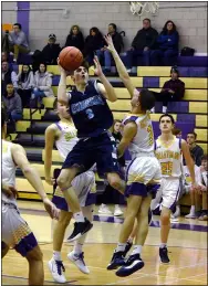  ?? STAN HUDY/ THE SARATOGIAN ?? Columbia junior Timothy Strevell leaps up as he drives towards the hoop, challenged by Ballston Spa’s Kyle Blair Monday night in Suburban Council action at Ballston Spa High School.