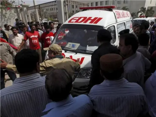  ??  ?? Rescue workers make way for an ambulance carrying victims of an attack on a bus