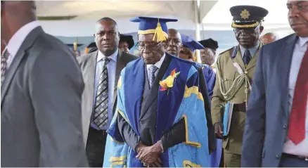  ?? TSVANGIRAY­I MUKWAZHI ASSOCIATED PRESS ?? Le président zimbabwéen Robert Mugabe (au centre) a refait surface en public vendredi, pour la première fois depuis que l’armée a pris le contrôle du pays. Il a assisté à une cérémonie de remise de diplômes universita­ires en compagnie de ses gardes du...