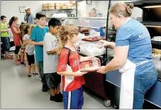  ?? Janelle Jessen/Herald-Leader ?? Kids lined up for lunch at the Middle School on Monday morning. The Siloam Springs School District’s summer lunch program is offering free weekday lunches for all kids under the age of 18 at the Middle School, Allen Elementary and three mobile sites...