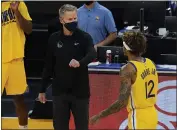  ?? JEFF CHIU — THE ASSOCIATED PRESS ?? Warriors head coach Steve Kerr, left, greets forward Kelly Oubre Jr. (12) during the second half Monday against the Kings in San Francisco.