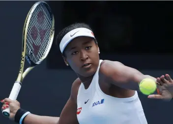 ?? — AP ?? Naomi Osaka of Japan eyes the ball as she plays against Alison Riske of the United States during their third round of the women's singles match in the China Open tennis tournament in Beijing on Thursday.