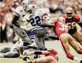  ?? Eric Gay/Associated Press ?? Cowboys running back Emmitt Smith (22) makes his way past the 49ers’ Merton Hanks (36) and Bill Romanowski during the Cowboy’s 38-21 win in the 1994 NFC championsh­ip. The 49ers-Cowboys playoff history is a rich one from back-to-back conference title games in the early 1970s, the iconic “Catch” in the 1981 season and then the heated rivalry in the 1990s when the Cowboys won the first two meetings on the way to Super Bowl titles and then the Niners took the third game.