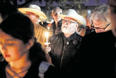  ?? Tom Fox / Dallas Morning News ?? Stephen Willeford, center, the man who confronted and exchanged gunfire with the Sutherland Springs church shooter in 2017, joins church and community members for a vigil Monday at the West Freeway Church of Christ in White Settlement.