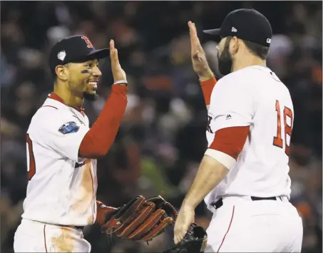  ?? Matt Slocum / Associated Press ?? Mookie Betts and Mitch Moreland celebrate after their Game 2 win in the World Series on Wednesday.