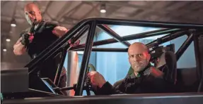  ?? DANIEL SMITH ?? Frenemies Hobbs (Dwayne Johnson) and Shaw (Jason Statham) team up to take on a villain in “Fast & Furious Presents: Hobbs & Shaw.”