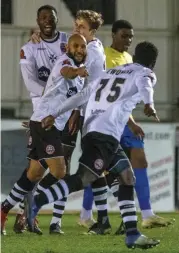  ??  ?? The Magpies celebrate after a goal.