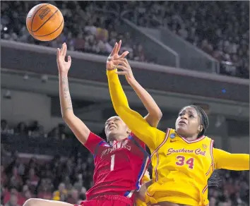  ?? Jayne Kamin-Oncea Getty Images ?? USC CENTER Clarice Akunwafo, right, goes up for a rebound against Kansas’ Taiyanna Jackson during the second half of an NCAA tournament game at Galen Center. Akunwafo finished with nine rebounds.