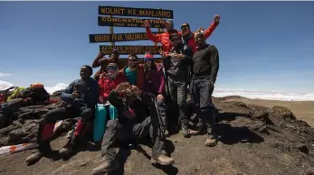  ??  ?? The cheerful 7 Summits Africa team on top of Tanzania’s Mount Kilimanjar­o. In front are assistant guides Edward Olariv and Ayoub Mikoki. Second row, Gabriele Brown, Patrick Thomas, Jessica Flint. Back row, assistant guide Samwel Kuresoy, East Africa...