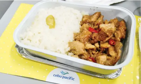  ??  ?? SKY DINING. Cebu Pacific’s Chicken Sisig was a delightful meal during our ManilaDenp­asar flight. The dish is among the new set of preorder meals of Cebu Pacific.