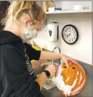  ?? (Courtesy Photo/Lonnie Moll) ?? Newsom practices her patient-care skills by shaving a balloon. Before shaving a person, students practice by shaving a balloon.