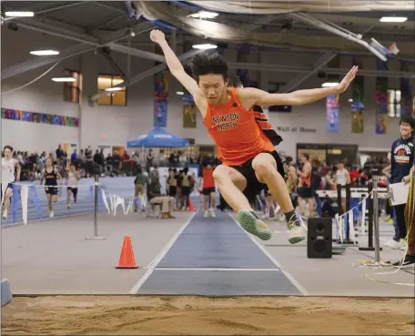  ?? LIBBY O’NEILL — BOSTON HERALD ?? Newton North’s Sam Huang competes in the long jump during the Div. 1 Coaches Relays at the Reggie Lewis Center in Roxbury.